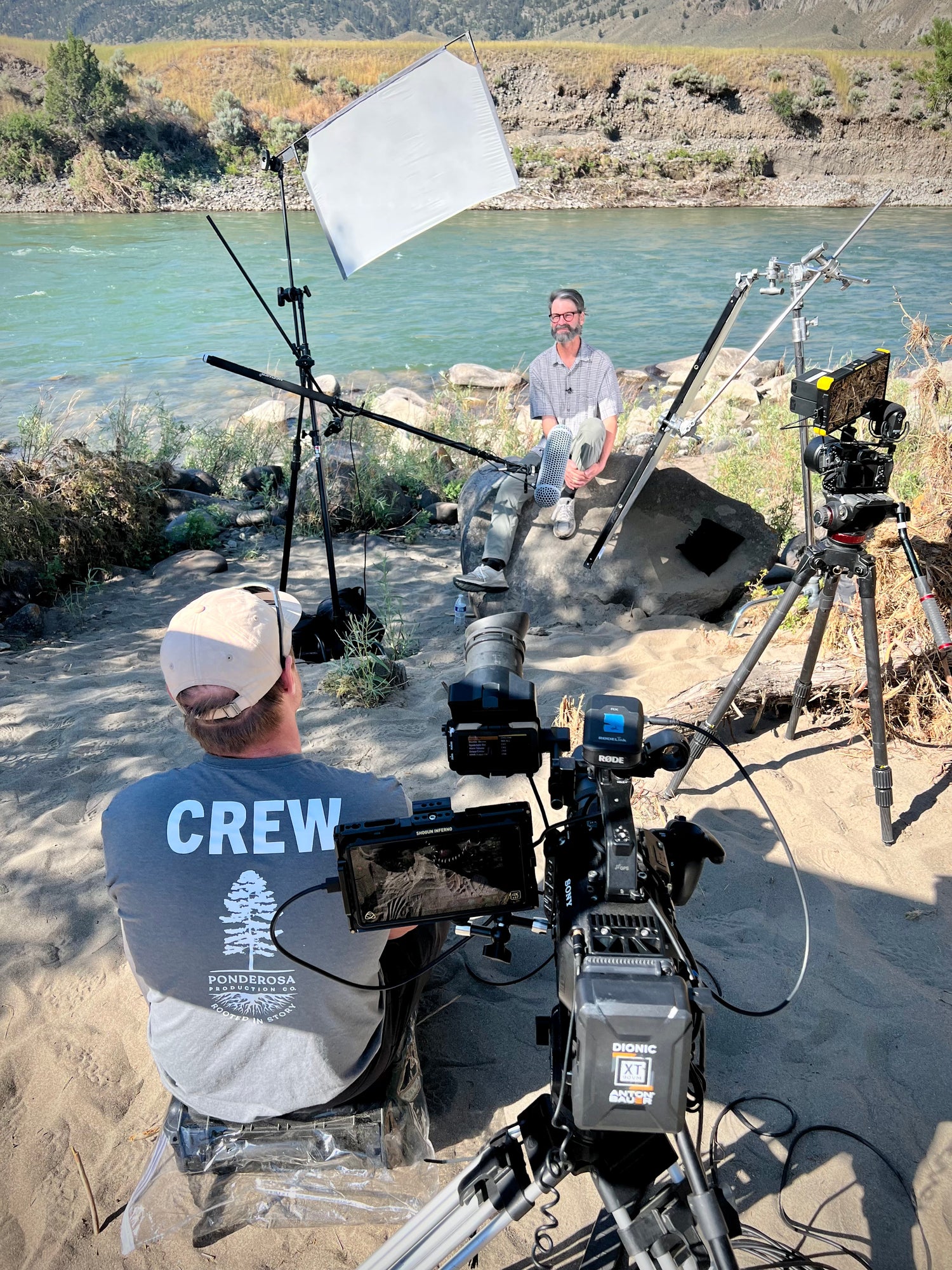 Robby Hirst documentary producer interviews a Montana business owner along the Yellowstone River. 