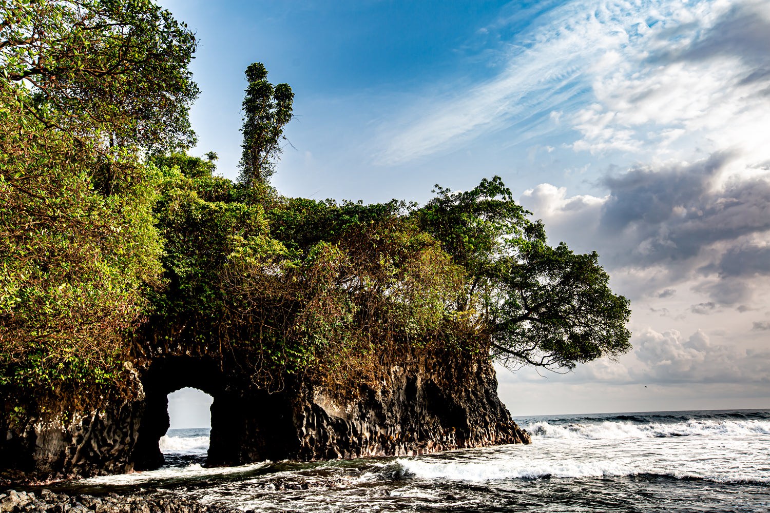 Robby Hirst Fine Art Photography | Equatorial Guinea Bat Cave with blue skies and ocean. 